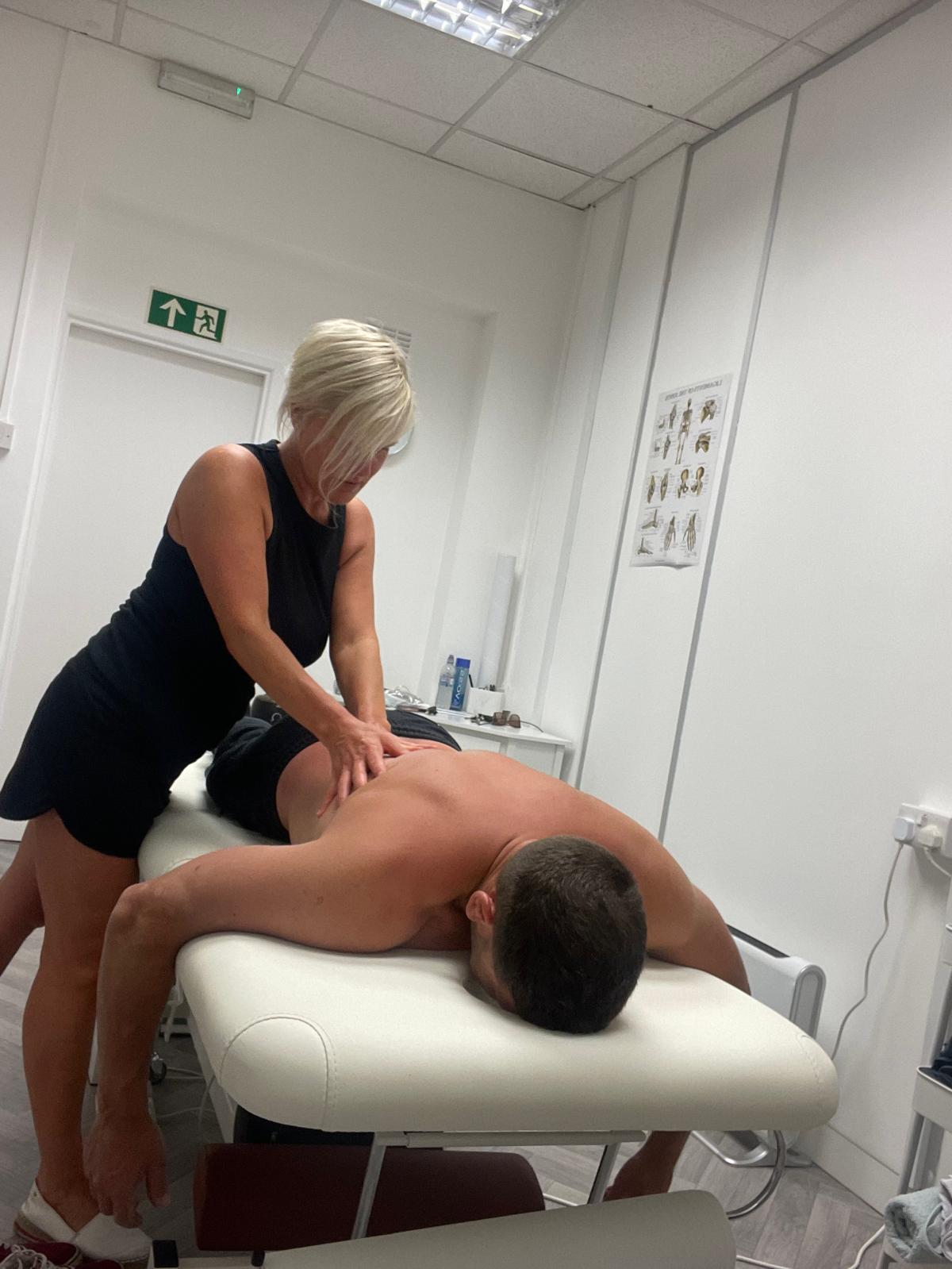Lisa providing hands-on lower back treatment